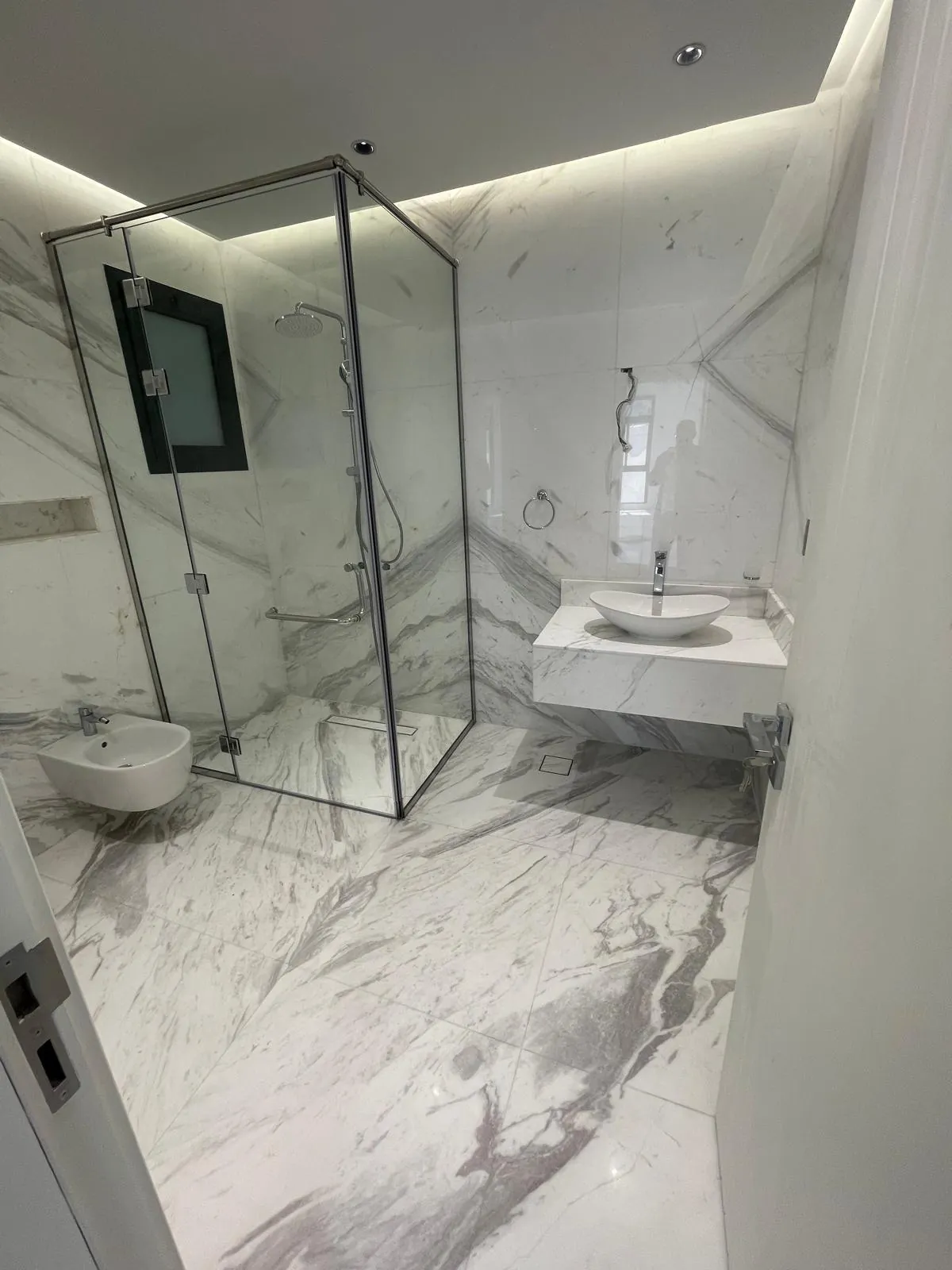 Marble bathroom with frameless glass shower